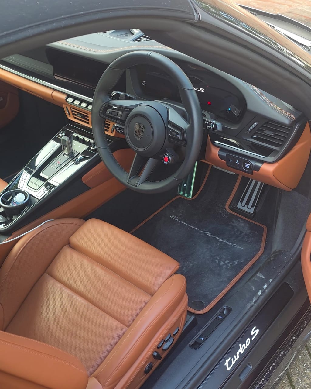 Cognac leather interior of a Porsche 911 Turbo S before the interior side of a maintenance valet