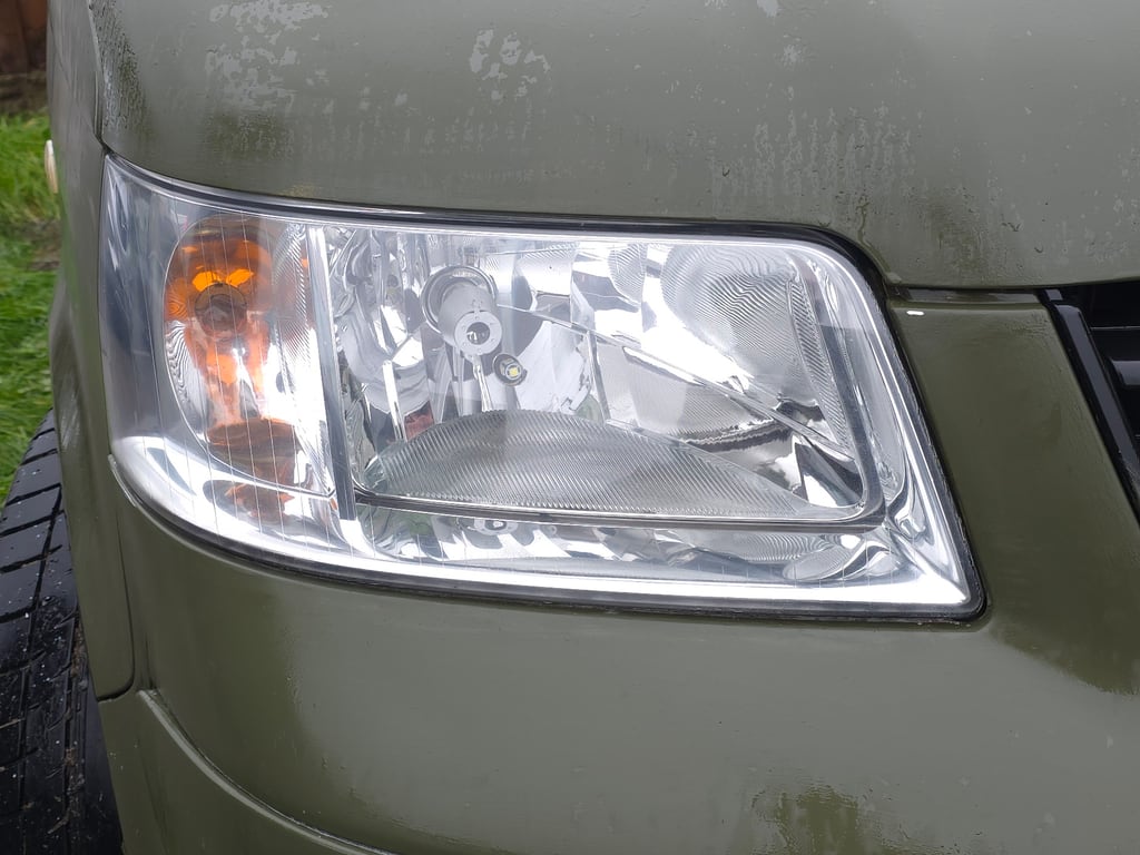 VW Transporter T5 headlight after restoration in Wolverhampton, the lens clear enough to show the reflector and bulb behind it