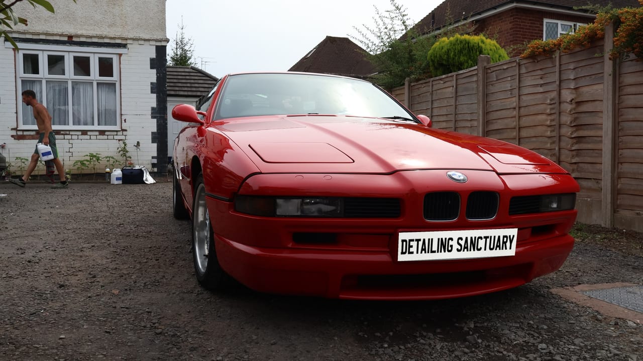 Long dark BMW flank reflecting cleanly after decontamination