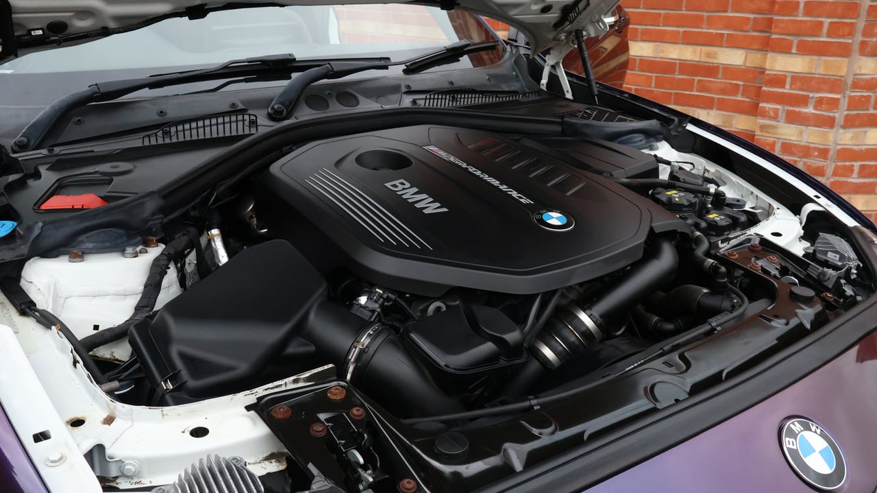 BMW engine bay finished, covers and hoses dressed to a satin finish