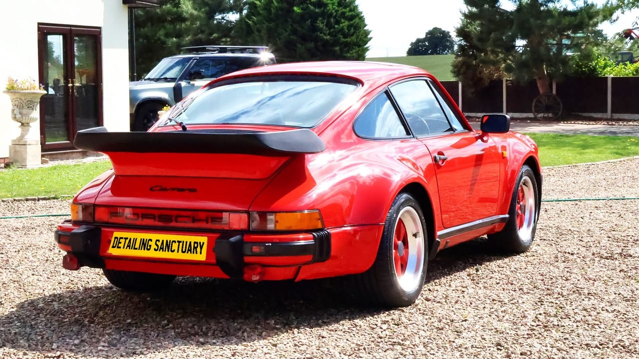 Red sports car paintwork after machine polishing and ceramic coating