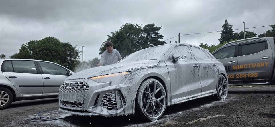 Snow foam pre-wash lifting road film before contact washing