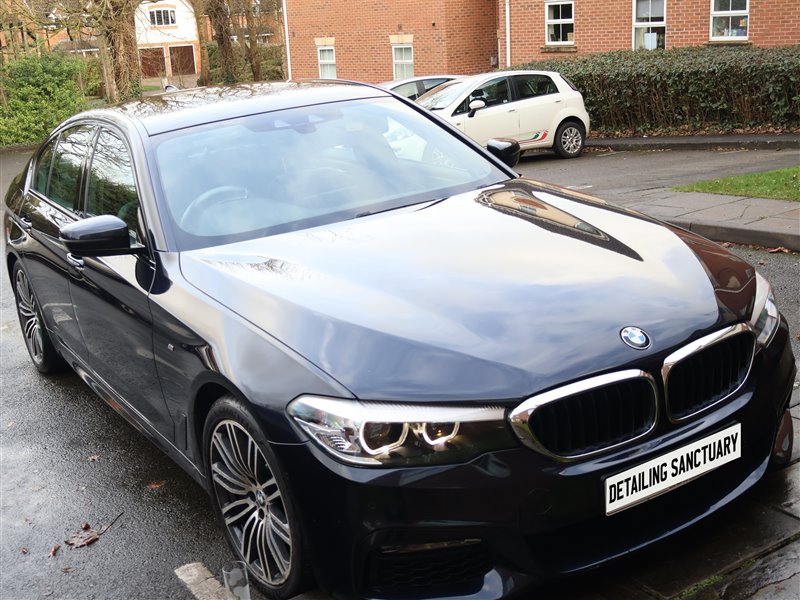 Black BMW 5 Series front end after paint enhancement
