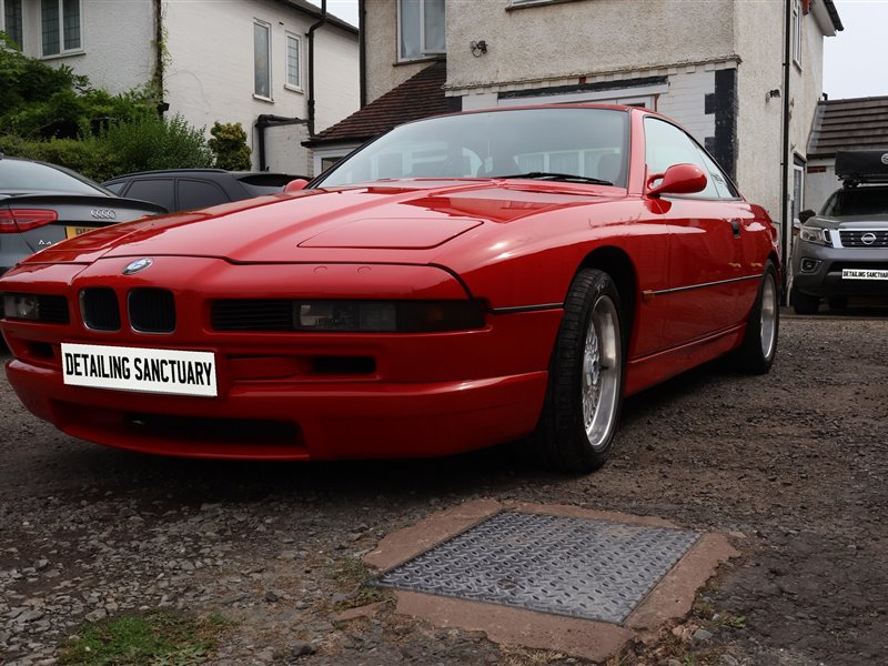 Red BMW 8 Series rear quarter after professional detailing