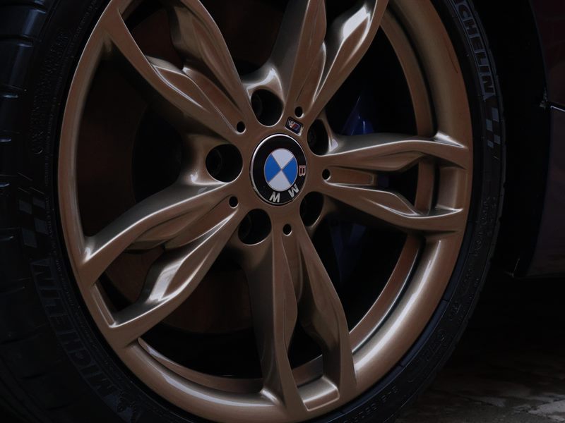 Bronze BMW M240i alloy wheel with blue brake calipers