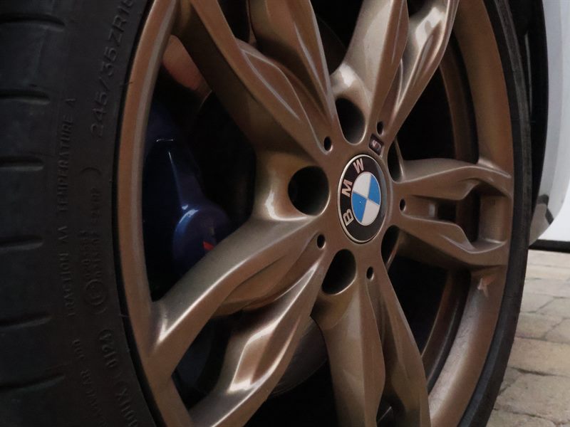 BMW alloy wheel with blue brake calipers after deep clean