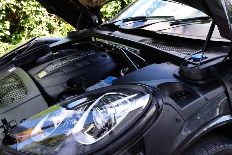 Porsche engine bay and headlight after cleaning, seen from the front of the car
