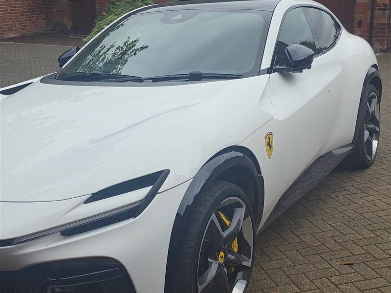Front three-quarter view of a white Ferrari Purosangue after detailing