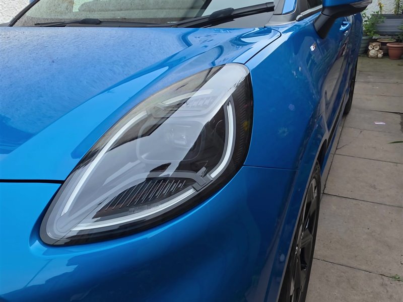Close-up of a Ford Puma headlight and paintwork after a ceramic coating