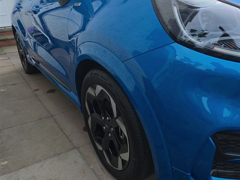 Blue Ford Puma ST-Line side view with gloss black alloys after a ceramic coating