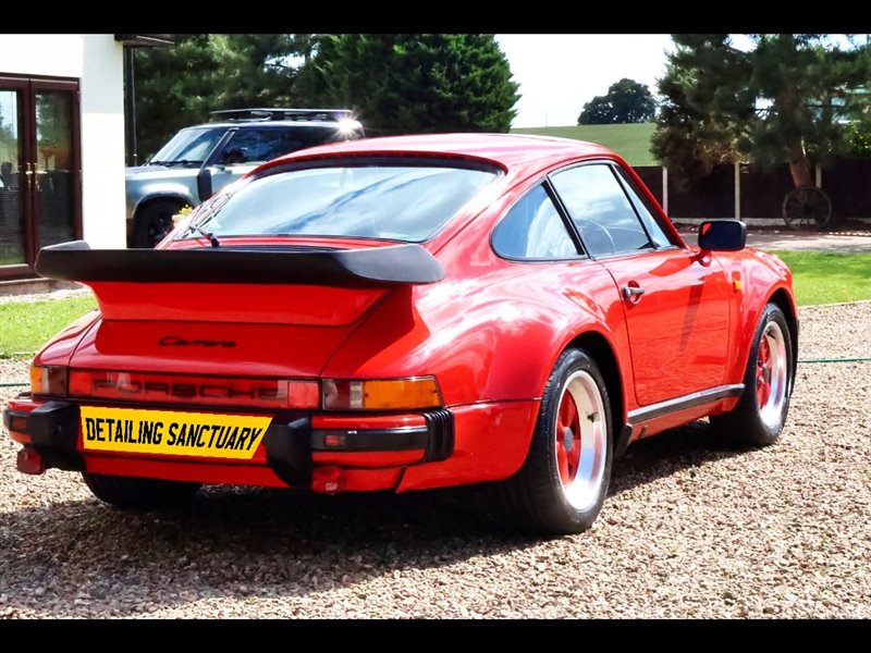 Classic red Porsche 911 Carrera rear with whale tail spoiler